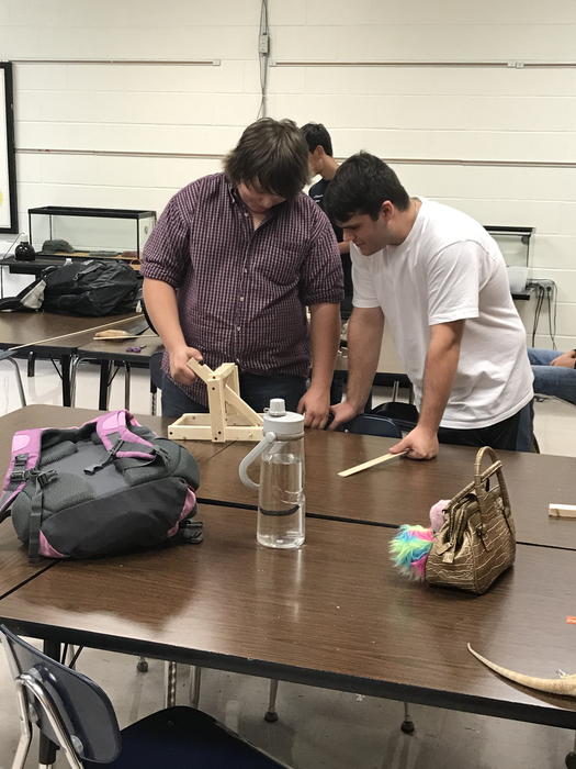 Students building trebuchet 